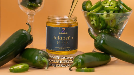 Jalapeño Ghee next to fresh Jalapeños. Use it in eggs, veggie, or sandwiches.